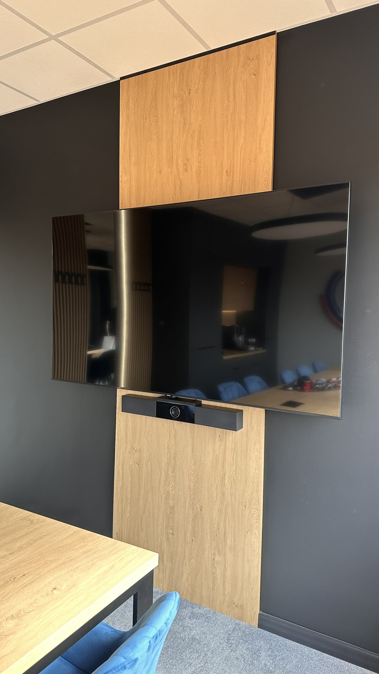 Drewniana zabudowa telewizora w przestrzeni biurowej CMPL